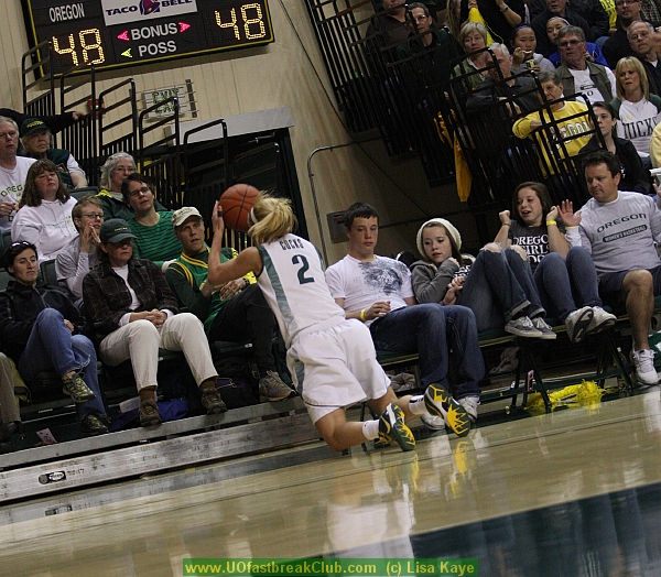 Cocks tries to keep ball alive with backward overhead pass before she goes out of bounds.