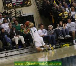 Cocks tries to keep ball alive with backward overhead pass before she goes out of bounds.